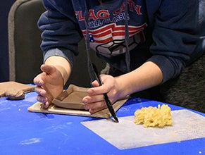 Artist working with clay